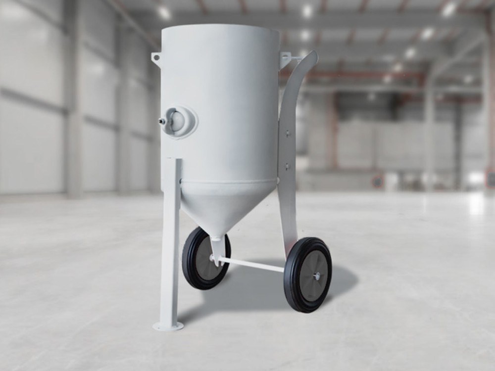 Mobile blast pot on a rolling chassis in a workshop