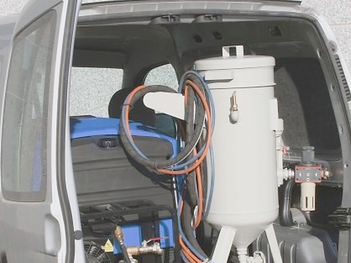 Mobile blasting system loaded in the back of a small van