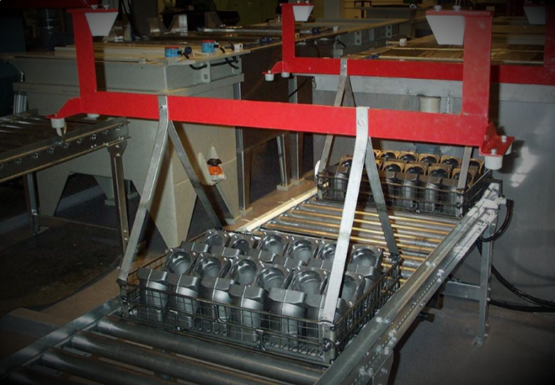 Automated line lowering a basket of parts into the tank